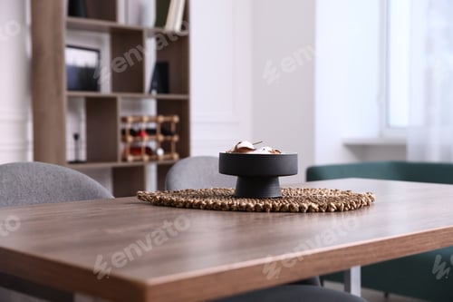Preview: Wooden table with chairs and decor in dining room, closeup. Interior design