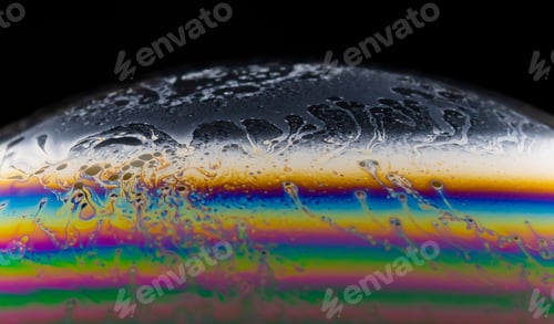 Preview: Macro shot of a colorful soap bubble on a dark background