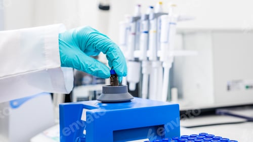 Preview: Close up of a woman shaking samples using a vortex mixer before HPLC analysis.