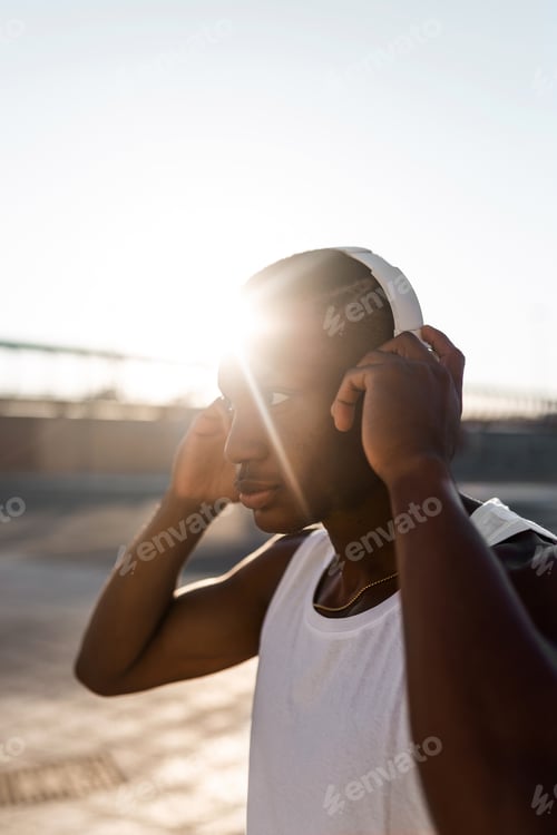 Preview: Black sportive man listening to music