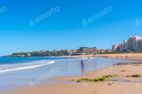 Preview: An elderly woman walking on the beach in Biarritz, Lapurdi. France, South West resort town
