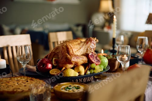 Preview: Roast turkey for Thanksgiving meal at dining table.