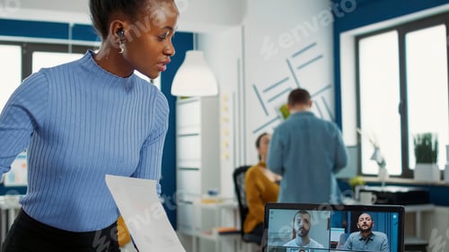 Preview: African american woman using laptop in online meeting with clients and manager talking about