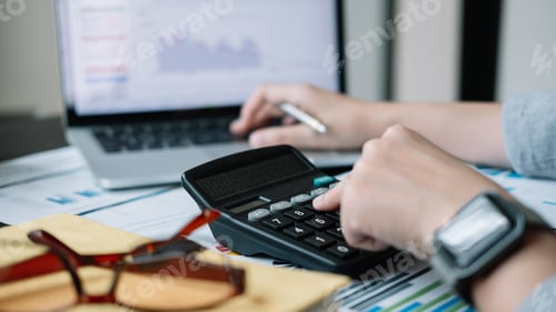 Preview: accountant working on desk using calculator for calculate finance report at home