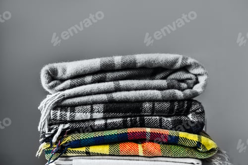 Preview: Stack of woolen checked blankets