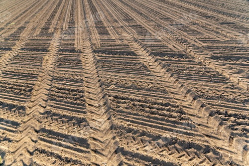 Preview: Plowed field brown soil tractor tracks