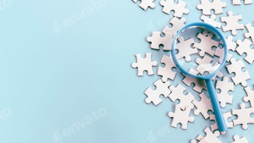 Preview: Magnifying Glass Over Jigsaw Puzzle Pieces for Detailed Inspection