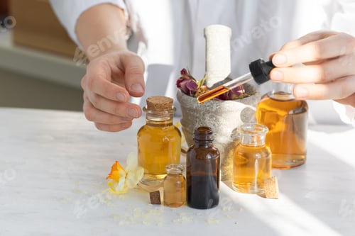 Preview: Female scientist doing laboratory research with natural organic essential oils. Flower extracts
