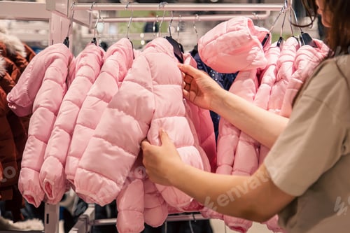 Preview: Children's jackets on hangers in a clothing store.