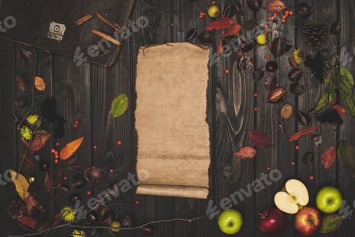 Preview: top view of dried autumn leaves, ripe apples and blank parchment on wooden surface