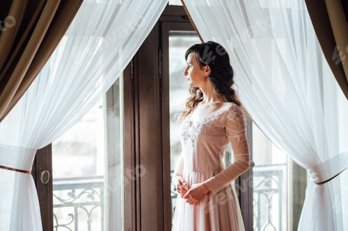 Preview: A girl in a light pink dress against the background of a medieva castle