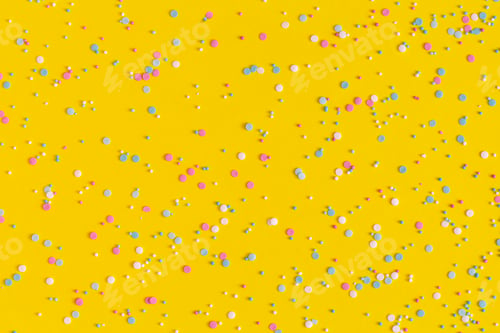 Preview: Colorful sprinkles on a yellow background