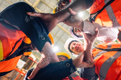 Preview: Group of diverse industrial worker work together in manufacturing plant. A