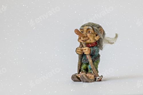 Preview: Figure of a troll skiing under the snow on a white background. Symbol of Norway.