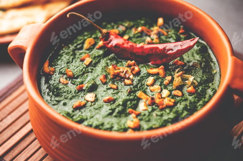 Preview: lasooni palak recipe or dhaba style garlic spinach curry, Indian main course served with naan