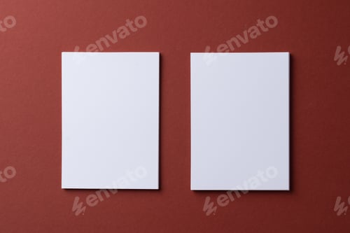 Preview: Blank white business cards on burgundy paper background