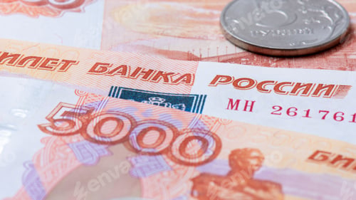 Preview: Closeup shot of Russian ruble banknotes and a coin
