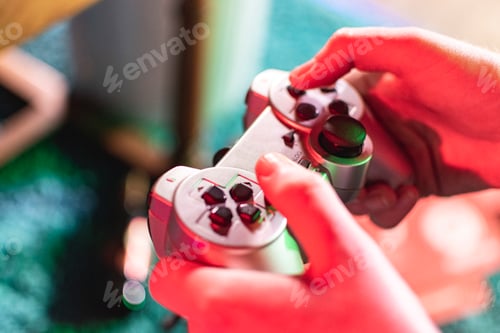 Preview: Gamer is holding a retro gaming controller in neon coloured light