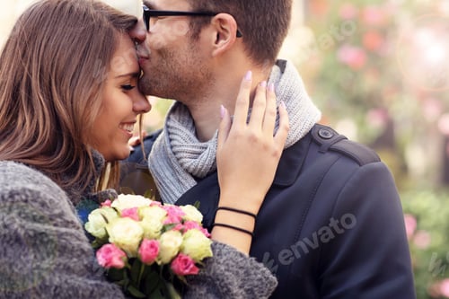 Preview: Woman with flowers giving hug to her man