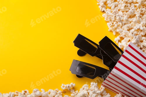 Preview: 3D glasses and popcorn on yellow background