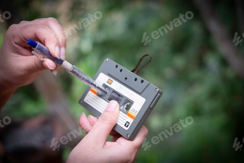 Preview: women rewind a cassette tape Vintage compact cassette