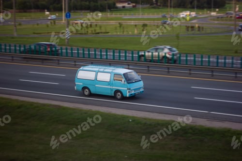 Preview: View of a blue hippie van on the road.