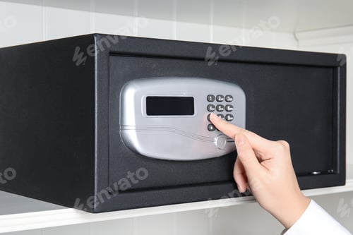Preview: Woman opening steel safe with electronic lock, closeup