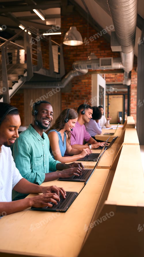 Preview: Portrait Of Customer Support Or Telesales Team In Modern Open Plan Office Wearing Headsets