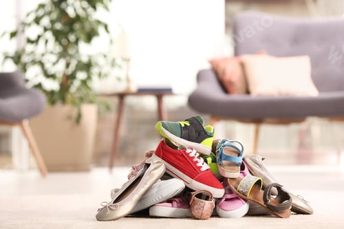 Preview: Heap of different shoes on floor in room. Space for text