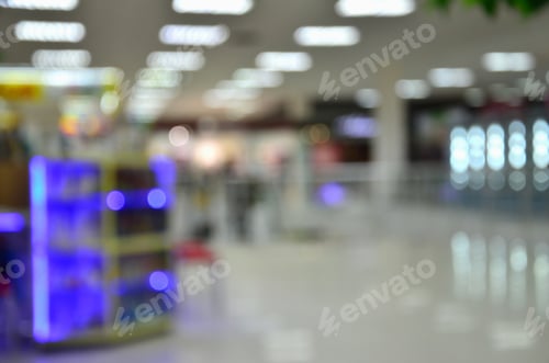 Preview: Blurred image of interior shopping mall or supermarket with bokeh effect in the luminous areas on