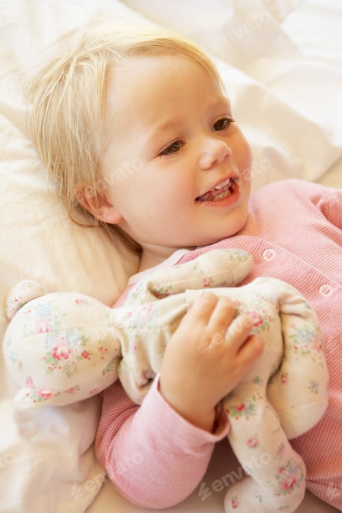 Preview: Young Girl Relaxing In Bed With Toy