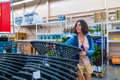 Preview: Woman choosing hanging egg chair in home improvement store