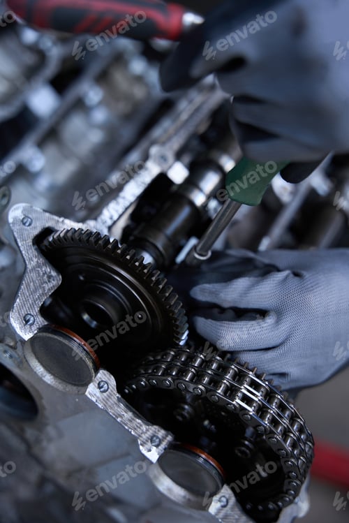 Preview: Master works in protective gloves when repairing engine of modern car