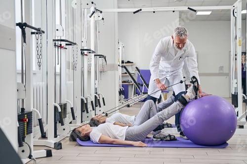 Preview: Patient performing a strength training exercise assisted by a kinesiologist
