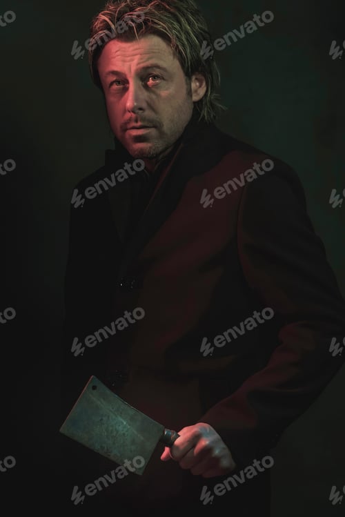 Preview: Threatening Man With Cleaver In Hand Illuminated By Red And Blue Light.