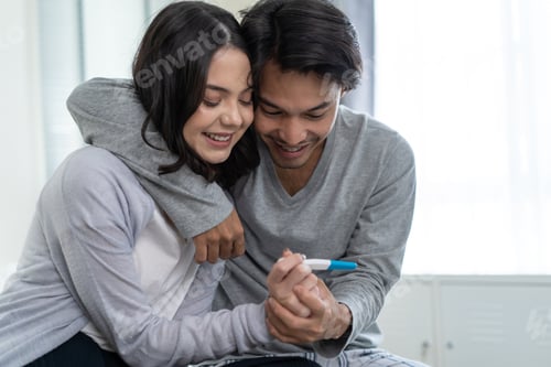 Preview: Asian young couple feeling happy after look at positive pregnancy test. Family-Expecting baby