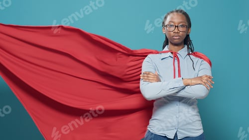 Preview: Portrait of female superhero wearing red cape costume
