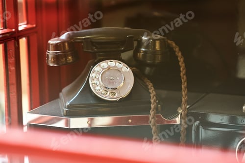 Preview: Vintage retro phone in a traditional british red booth close up