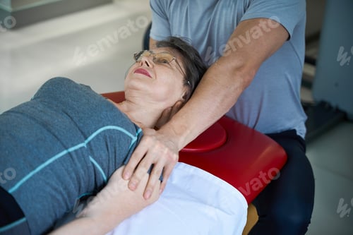 Preview: Chiropractor working on female patients cervical vertebrae