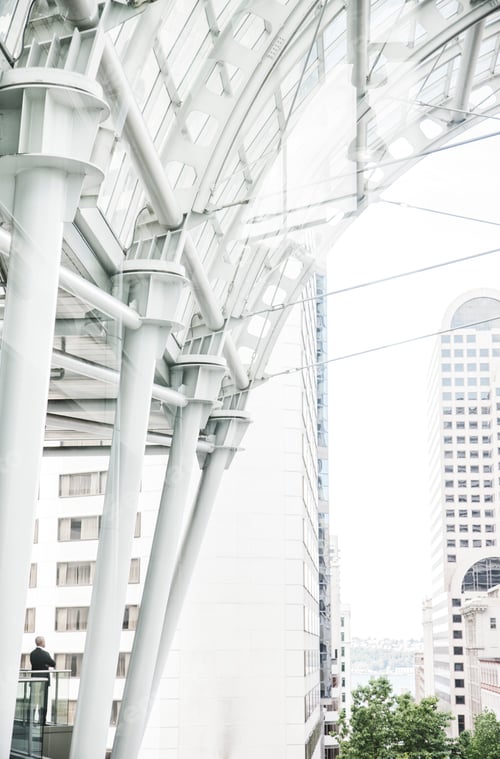 Preview: Caucasian business man standing on a balcony overlooking a cityscape.