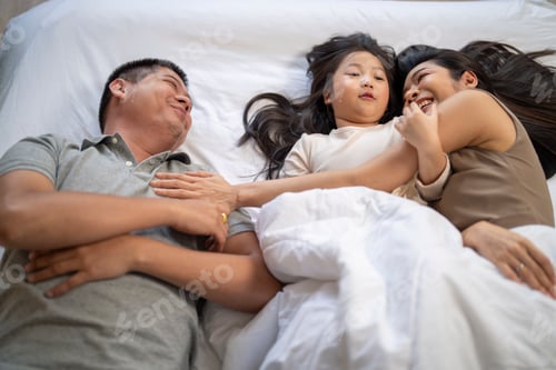 Preview: elderly couple sits in their living room. The man holds his knee