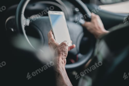 Preview: Man's hand holding a phone while driving, using phone for looking map in mobile.