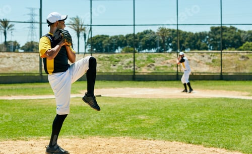 Preview: Full length shot of a handsome young baseball player pitching a ball during a match on the field