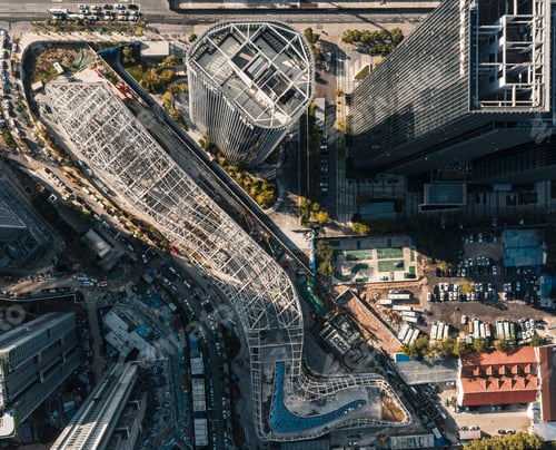 Preview: aerial photo of a city train track in between two buildings