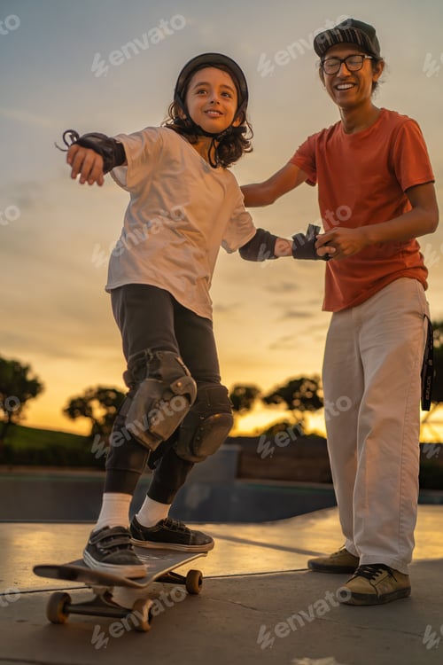 Preview: Boy in his first skateboarding lesson with his coach at the skate park