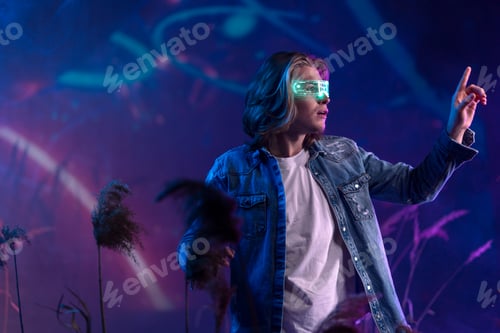 Preview: Metaverse digital cyber world technology, man with virtual reality VR goggles playing augmented