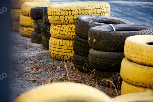 Preview: stack of car tires black and yellow, for racing track fencing