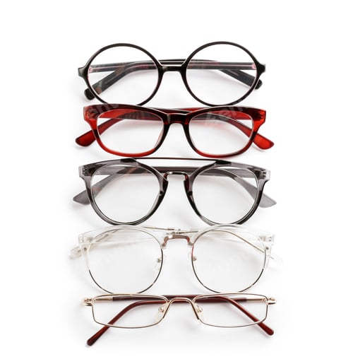 Preview: Different glasses with corrective lenses on white background. Vision problem