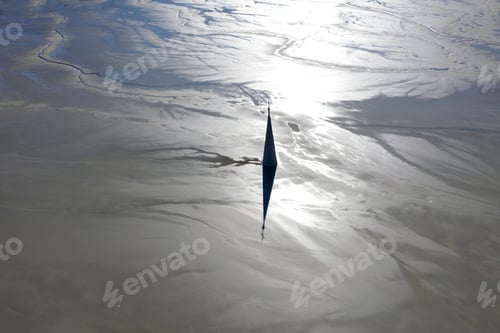 Preview: Aerial view of silhouette of church tower flooded by mining residuals. Apocalyptic scene