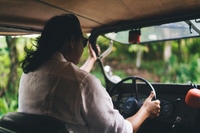 Preview: Man driving car on countryside road
